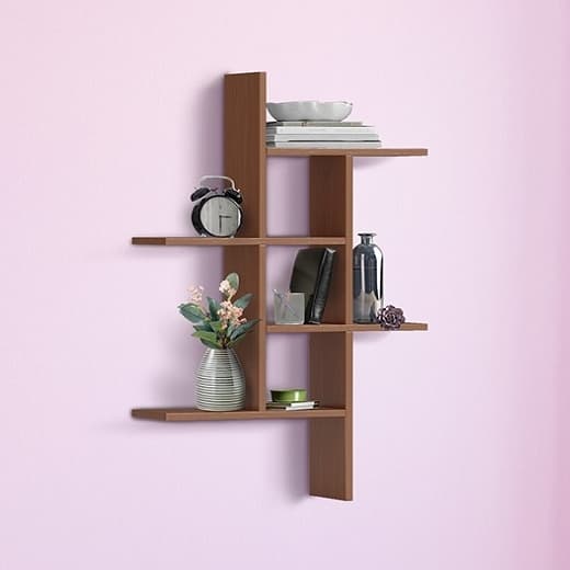 Walnut cascade wall shelf with three staggered tiers holding books, a vase and decor